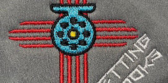 Zia symbol setting hooks logo custom embroidered onto a gray shirt.